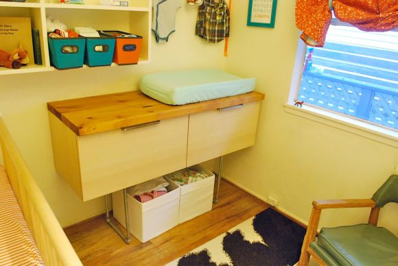 Changing table IKEA hack by Travis. The drawers are meant for bathroom cabinet. He added the wood planks on top and used pipes for legs.